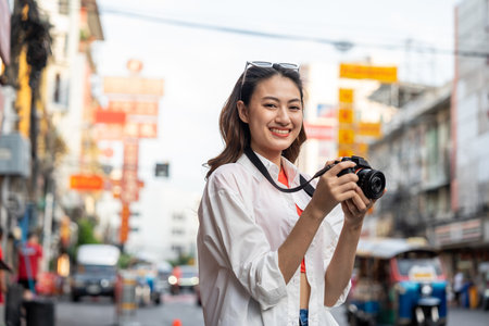 Asian woman enjoy eating street food at night market. Traveler Asian blogger women Happy tourists Beautiful female with Traditional food local road at thailand bangkok city.の写真素材
