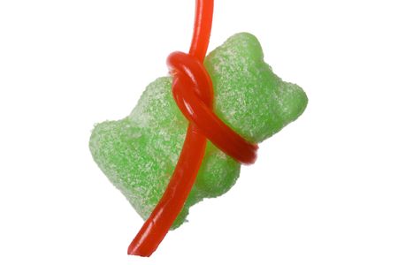 Green hanging jelly  on red string. Isolated on white.の写真素材