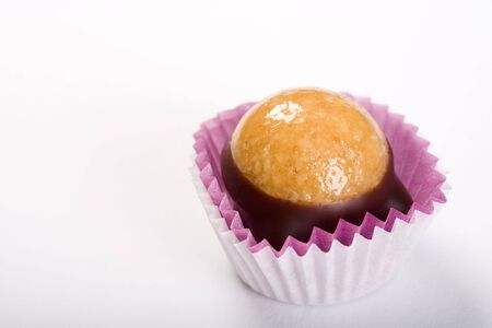 Single truffle - dark chocolate and marzipan. On white background.の写真素材