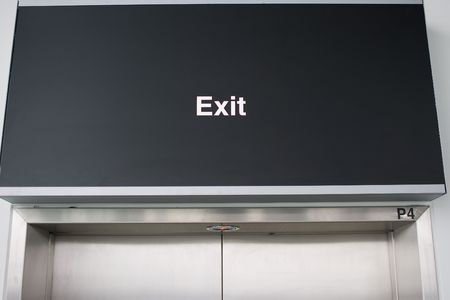 Exit-sign on black boardの写真素材