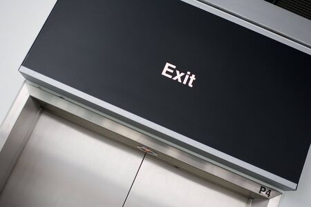Exit-sign on black boardの写真素材