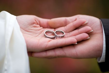 Wedding-rings in the palms of the married couple. Small DOF!