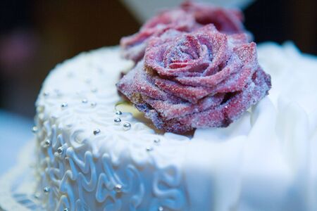 Close up of cake decorated with icing and flowers.の写真素材
