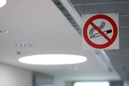 'No-Smoking' sign hung on a ceiling of a public place.の写真素材