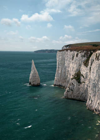 White large sharp rock in the turquoise sea in Ballard Down. August - 2019. Swanage, Englandの写真素材