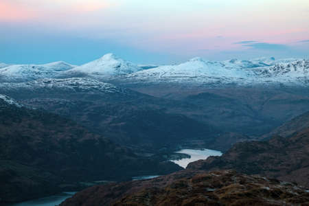 Evening view from the summit of Ben Lomond to the neighboring peaks and the lake Loch Lomond at sunset. Loch Lomond and The Trossachs National Park. Scotlandの写真素材