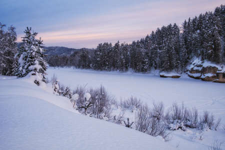 Tranquil winter landscape with frozen river and forest, river Lebed, Altai, Russiaの写真素材