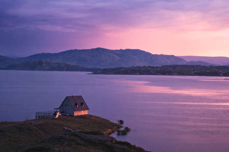 House on the shore of the lake at sunset, Bukhtarma Reservoir, Eastern Kazakhstanの写真素材
