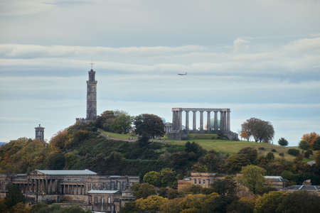 Amazing cityscape view of the Edinburgh city. Calton Hill with some of monuments - the National Monument, Dugald Stewart Monument, Nelsons Monument, the Old Royal High School.の写真素材