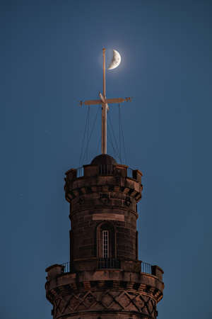 The Nelson Monument on Calton Hill at night in front of the crescent moon. Edinburgh, Scotlandの写真素材