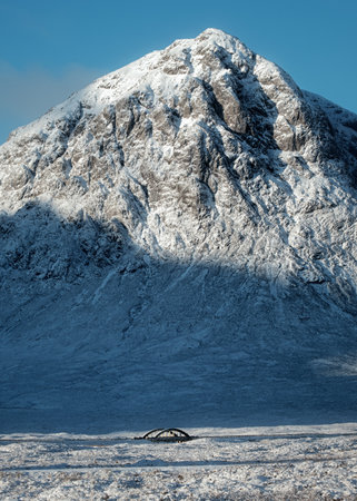 The bridge and road leading across the Scottish Highlands of Glen Coe with the snow mountain in the background. Buachaille Etive Mor. Scotlandの写真素材
