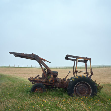Old style farm tractor sitting on a green grass field. Isle of North Uist, Scotlandの写真素材