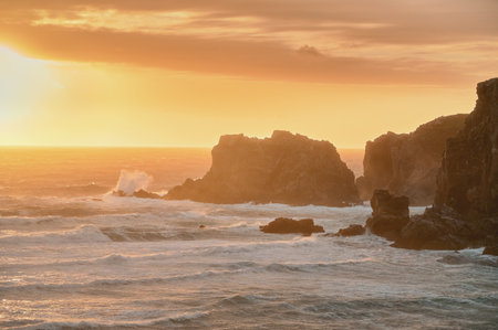 Ocean wave breaking on rocky shore, rough sea water at sunset on Isle of Lewis. Mangersta beach, Scotland. High quality photoの写真素材