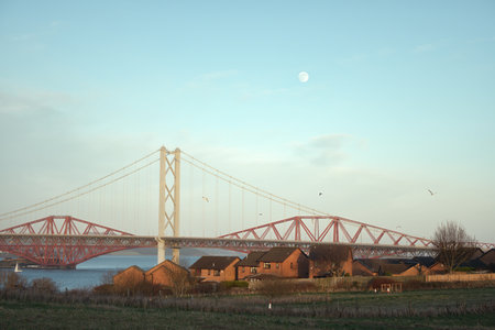 Two bridges through Fife at sunset. Forth Bridges crossing between Fife and Edinburgh at sunset, Scotland, United Kingdomの写真素材