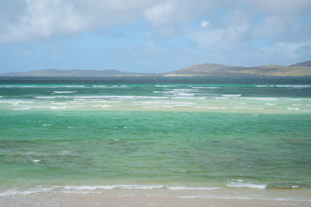 Turquoise sea and waves on a spectacular beach in the north of Scotland. Luskentyre sands, Isle of Harris, Scotlandの写真素材