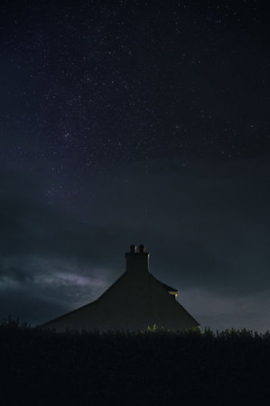 The night starry sky and a lonely house. Isle of Skye, Scotlandの写真素材