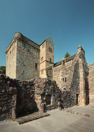Historic stone castle ruins under clear blue sky in Scotland. Medieval architecture and ancient heritage site.の写真素材