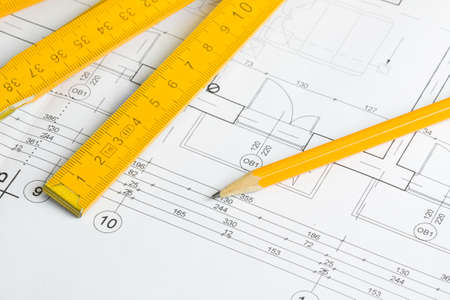 Architectural drawing, pencil and yellow wooden measurement tapeの写真素材