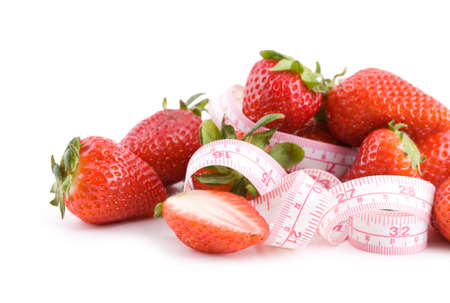 Fresh strawberries with measure tape isolated on whiteの写真素材
