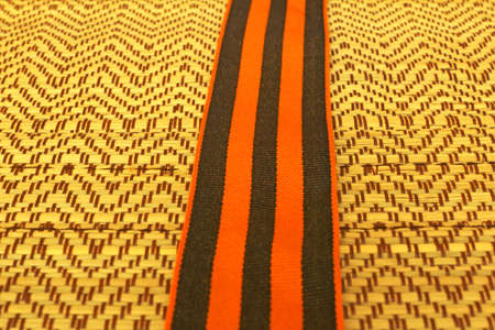 George Ribbon on a straw background.