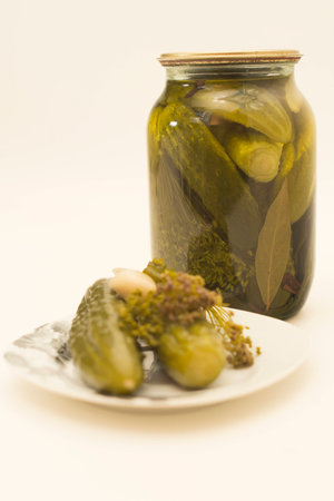 Bank and a plate of pickled cucumbers isolatedの写真素材
