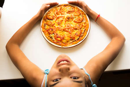 Pizza made from pork, cheese, tomatoes and herbsの写真素材