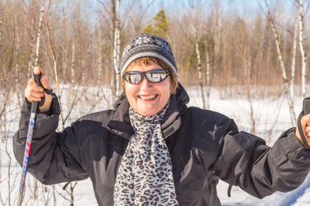 Woman in autumn winter forest skiing dayの写真素材