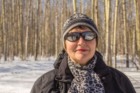 Woman in autumn winter forest skiing day