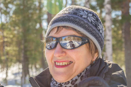 Woman in autumn winter forest skiing dayの写真素材