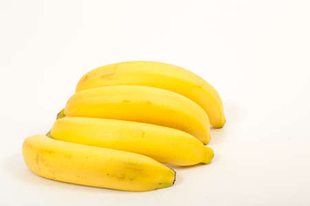 Four ripe banana yellow on a white backgroundの写真素材