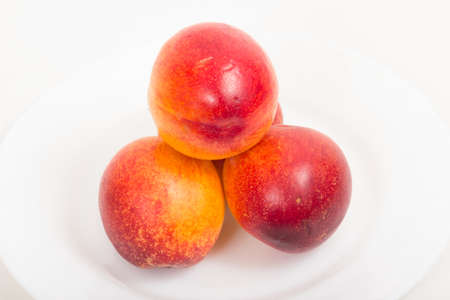 Ripe and fresh peaches on a white backgroundの写真素材