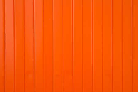 Background in the form of narrow and wide vertical orange stripesの写真素材