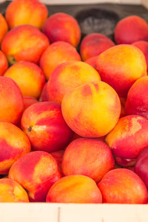 A bunch of fresh, ripe peaches for saleの写真素材