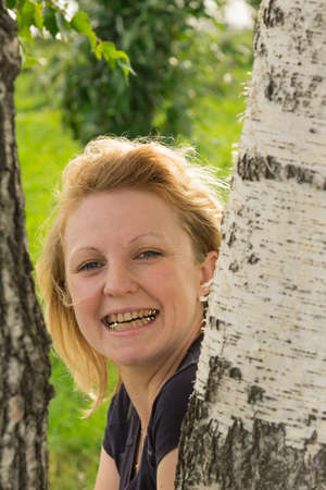 Portrait of a woman in white trousers on background of the urban landscapeの写真素材