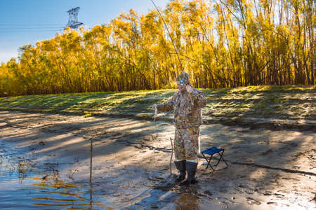 Fisherman caught fishing rod on earthworm big roachの写真素材
