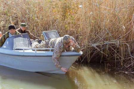Three fishermen catch fish on spinners in the Volga deltaの写真素材