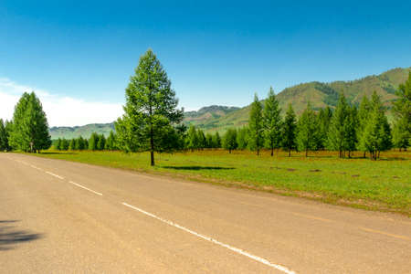 Country dirt road passes near the mountains