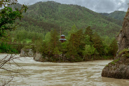 Muddy mountain river from melting snow flowing from the glacier peaks of the Altai Mountains