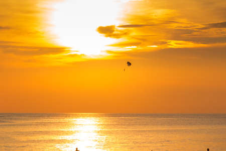 Parachutist on background of golden sunset skyの写真素材