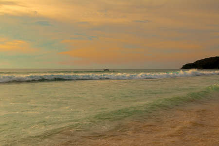 Evening on the sea and the sun gradually disappearing behind the horizonの写真素材