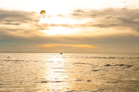 Parachutist on background of golden sunset skyの写真素材