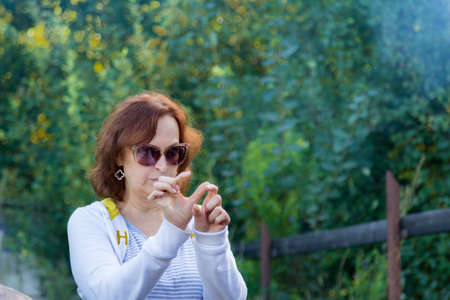 Portrait of a woman in glasses on the natureの写真素材