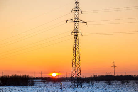 December early sunset against the background of a floodplain covered with snowの写真素材