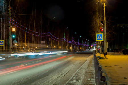 The night landscape of a small provincial town glowing in multicolored lightsの写真素材