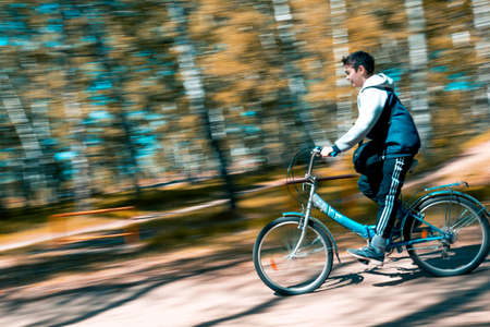 The guy rushes on a two-wheeled bike from the mountainの写真素材