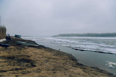 Aluminum boat on the river bank in the spring before the iceの写真素材