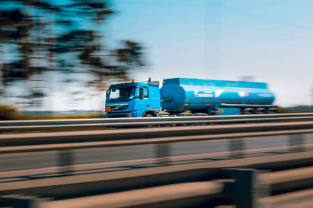 The car at high speed rushes along the motorway in the early July morningの写真素材