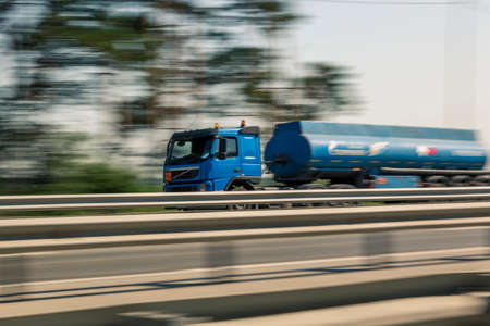 The car at high speed rushes along the motorway in the early July morningの写真素材