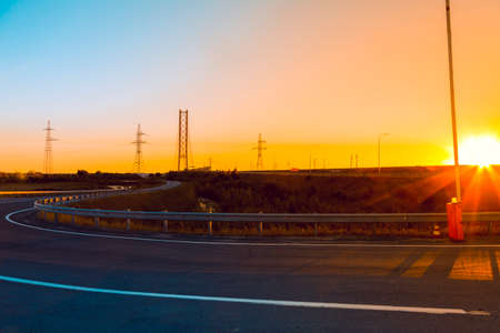 Asphalt road in the early July sunの写真素材