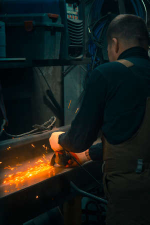 Portrait of a locksmith grinder in gloves at work